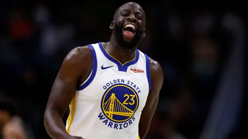 Draymond Green #23 of the Golden State Warriors interacts with a fan.